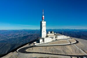Stunning aerial view of the Mont Ventoux Observatory in France under clear blue skies.